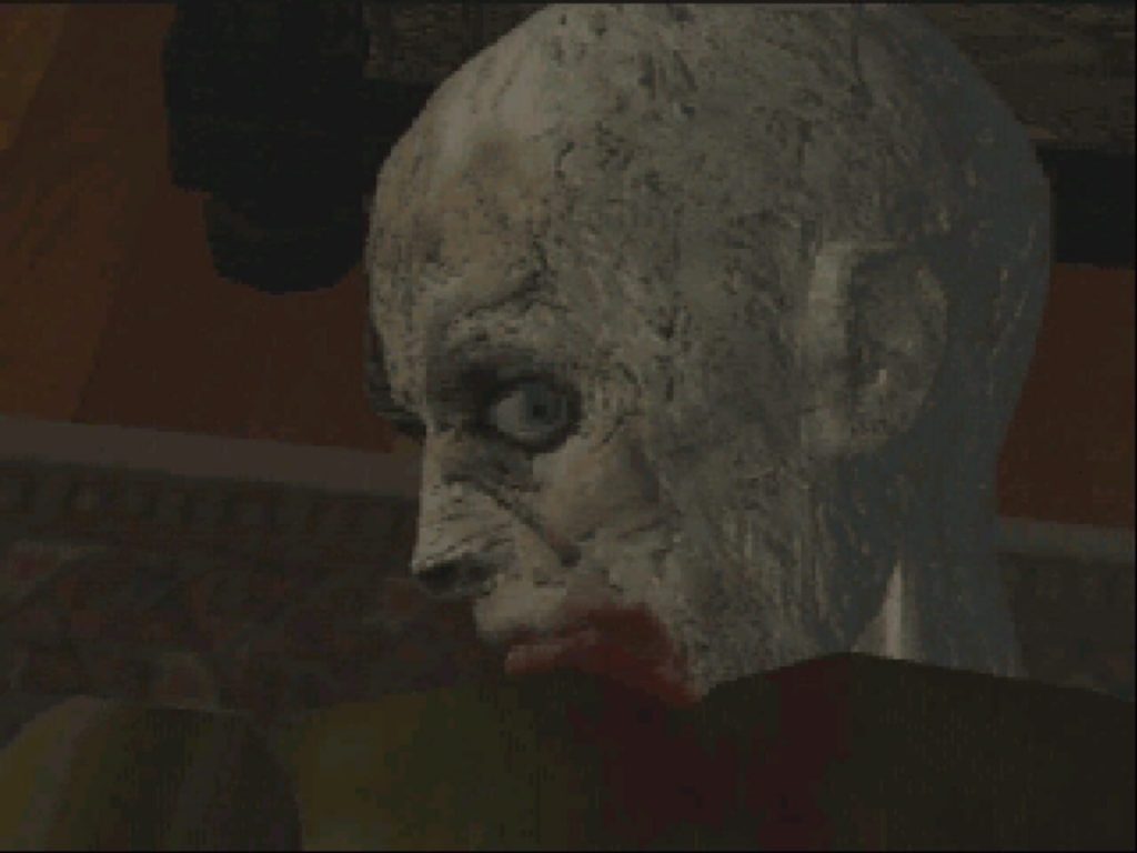 Gros plan sur le visage gris et la bouche sanglante d'un zombie dans Resident Evil sur PlayStation