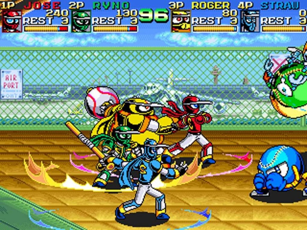 Quatre personnages robots colorés frappent une balle géante sur un terrain grillagé, avec les quatre jauges de joueurs en haut de l'écran