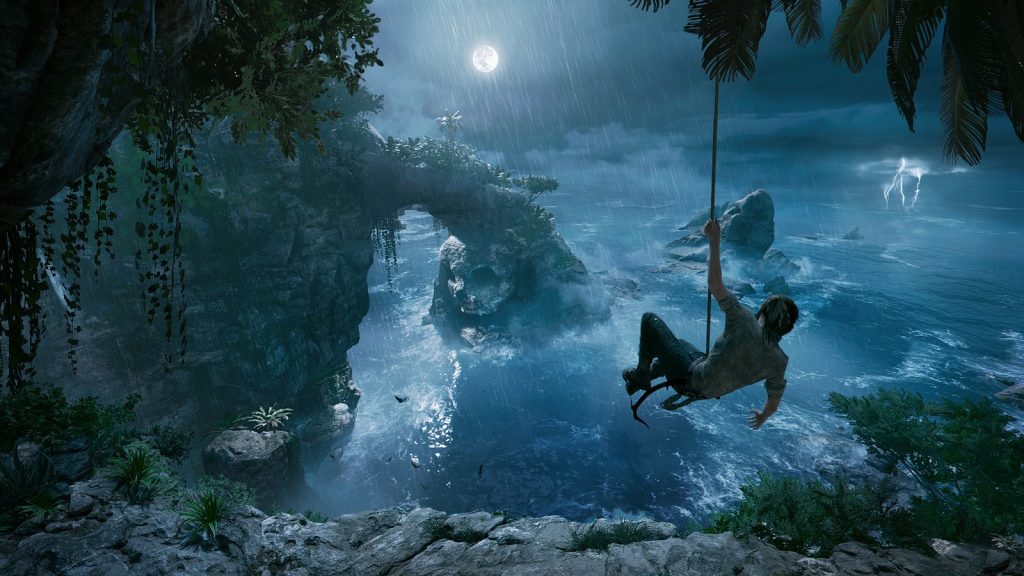Une silhouette se balance au bout d'une corde au-dessus d'une côte rocheuse, sous la pluie et la pleine lune.