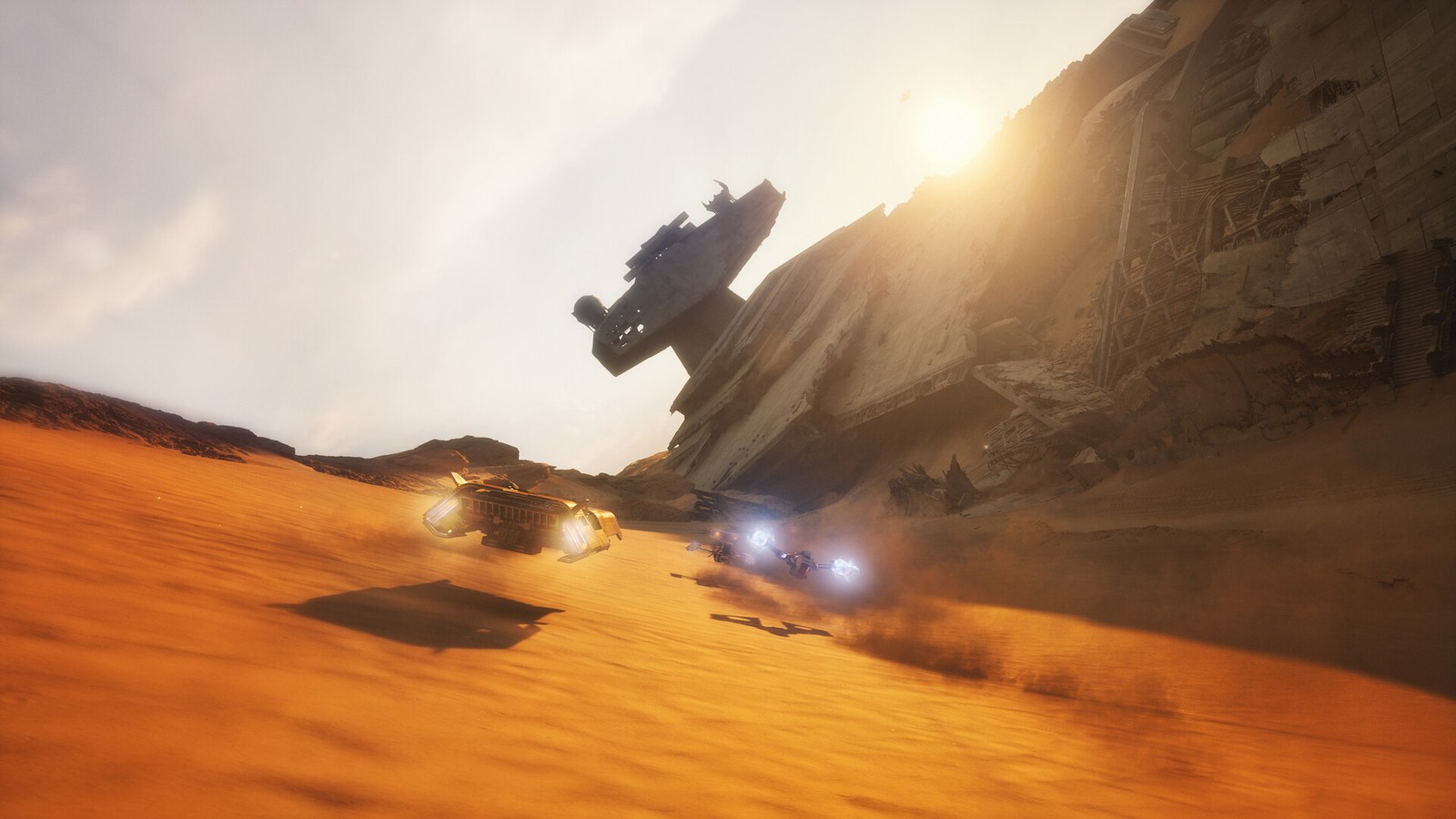 Un module de course file au ras du sable dans un désert, à contre-jour d'un soleil bas.