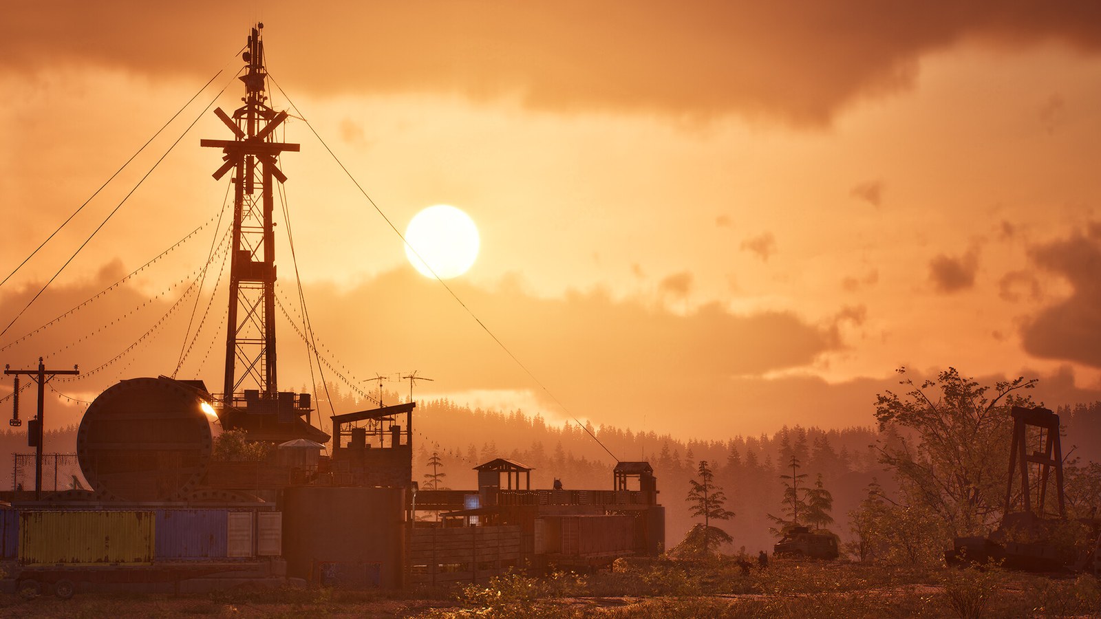 Un soleil orange se couche sur un paysage industriel abandonné, pylônes et bâtiments bas sous un ciel chargé.